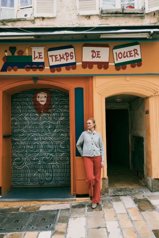 a woman standing in front of a building