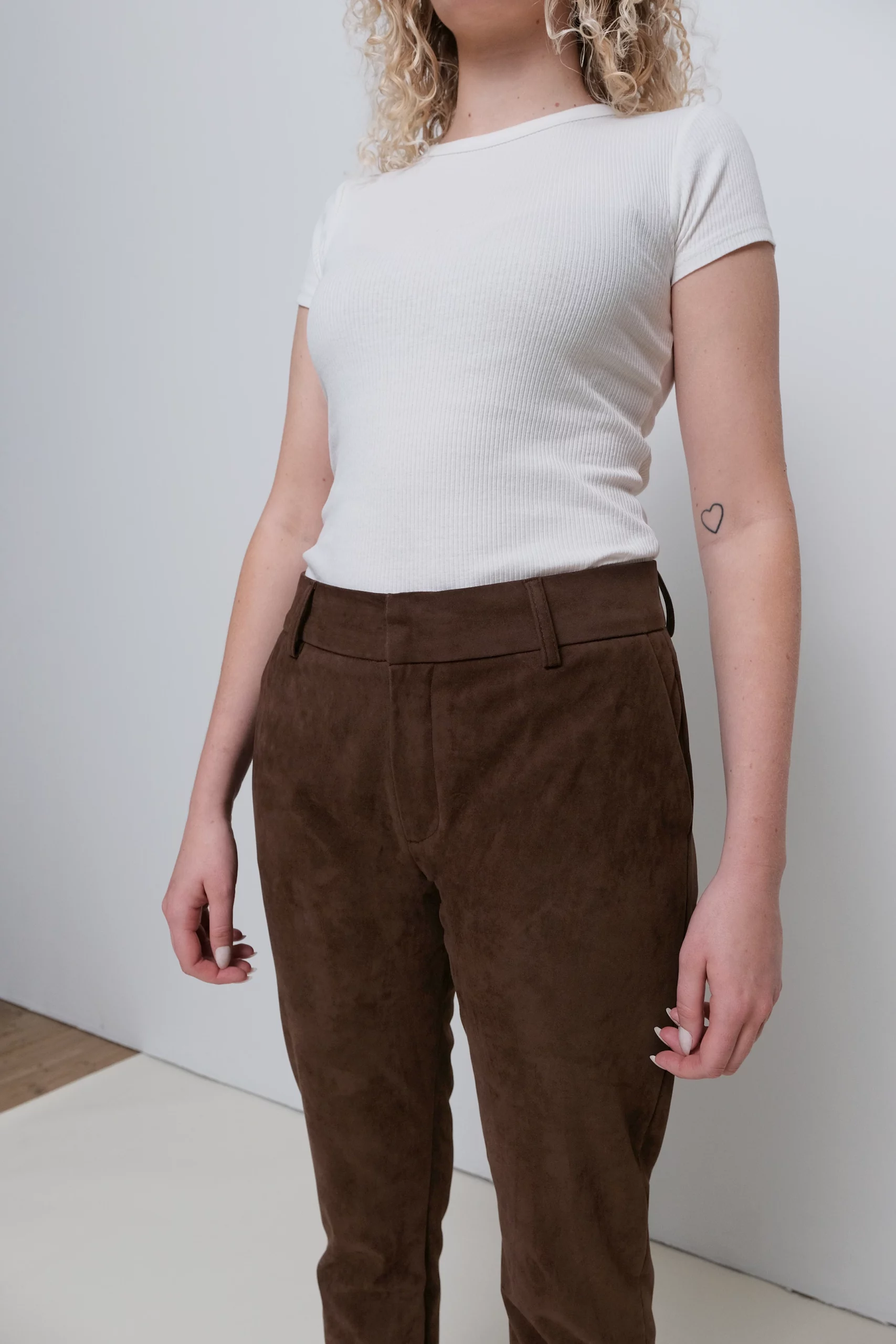 a woman wearing brown pants