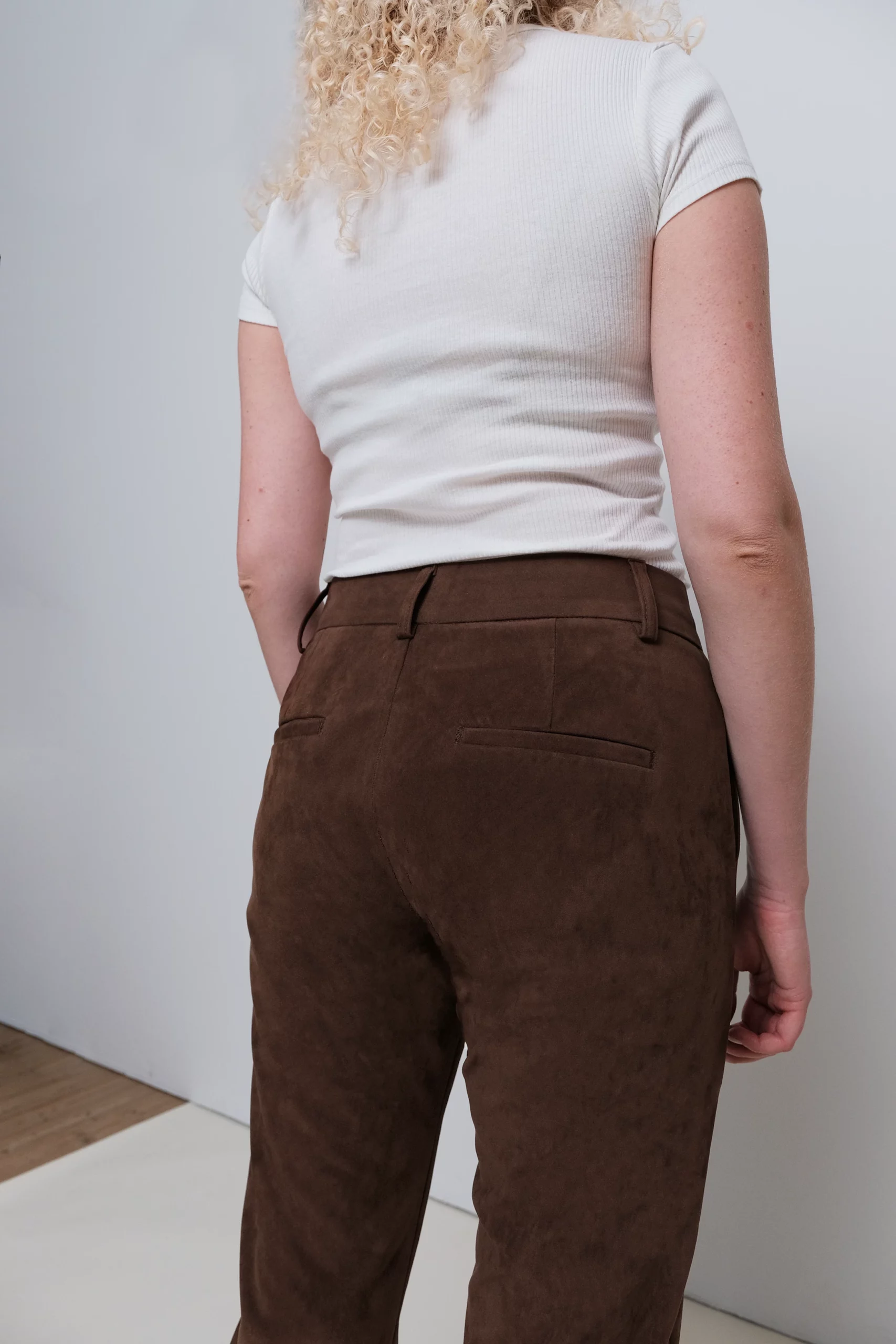 a woman wearing brown pants