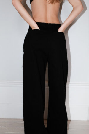 Girl wearing black chino pants with extra long legs