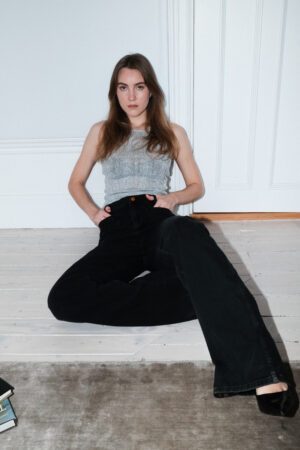 Girl wearing black denim pants with extra long legs