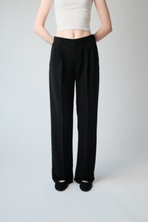 Girl wearing black suit pants with extra long legs