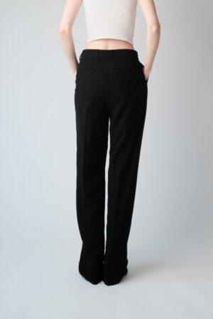 Girl wearing black chino pants with extra long legs