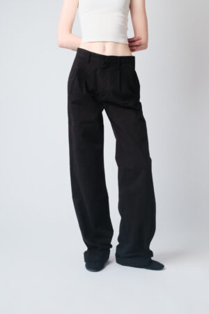 Girl wearing black chino pants with extra long legs