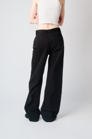 Girl wearing black chino pants with extra long legs
