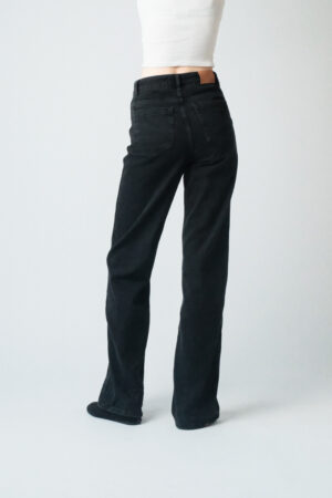 Girl wearing black denim pants with extra long legs