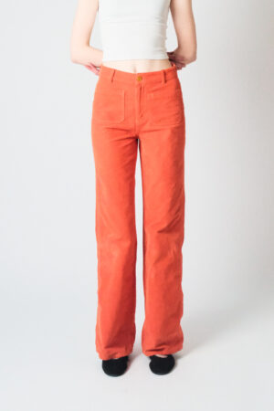 Girl wearing orange corduroy pants with extra long legs